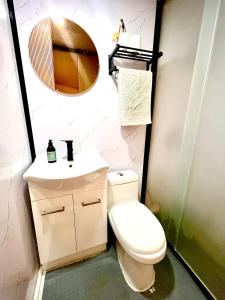 a bathroom with a toilet and a sink and a mirror at One life Glamping Tent in Rawson