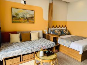 a small room with two beds and a couch at Măng Homestay in Kim Quan +26 photos