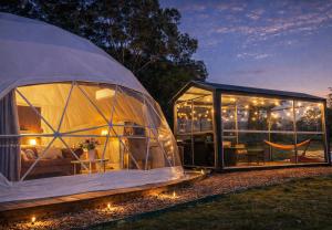 a large greenhouse with a table inside of it at One life Glamping Tent in Rawson