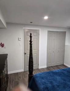 a bedroom with a bed and a pole in front of two doors at Peaceful escape in Ottawa