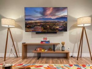 a living room with two lamps and a tv on the wall at Mountain View Adventures in Heber City