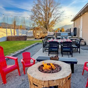 a patio with a table and chairs and a fire pit at Mountain View Adventures in Heber City