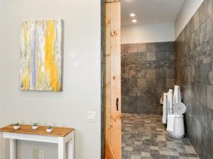 a bathroom with a toilet and a painting on the wall at Mountain View Adventures in Heber City +32 photos