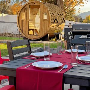 a table with a red table cloth and a wooden cabin at Mountain View Adventures in Heber City