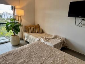 Llit o llits en una habitació de Departamento Studio