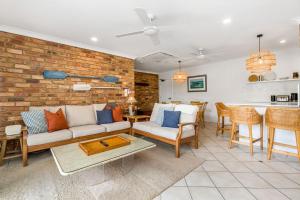 a living room with a couch and a table at Atlantis 6 - 70 Lawson Street in Byron Bay