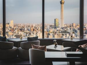 a room with tables and chairs and a view of a city at Asakusa View Hotel in Tokyo