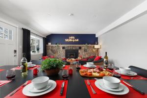 a dining room with a table with red napkins and a table sidx sidx sidx at Maple Street Retreat in Bellaire +35 photos
