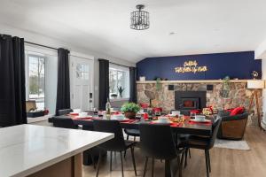 a dining room with a table and chairs and a fireplace at Maple Street Retreat in Bellaire