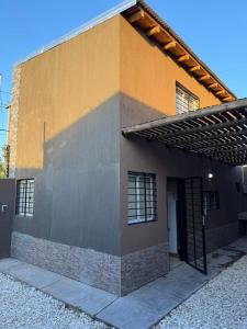 a building with a door on the side of it at Complejo Indanna in San Rafael