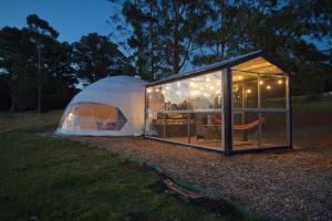 a tent sitting on the grass in a field at One life Glamping Tent in Rawson +14 photos