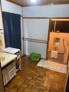 a small bathroom with a sink and a shower at 釣り宿yasakabase guesthouse in Sado +42 photos