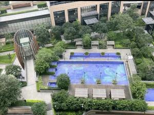 an overhead view of a building with a swimming pool at Happy Hours in Shenzhen