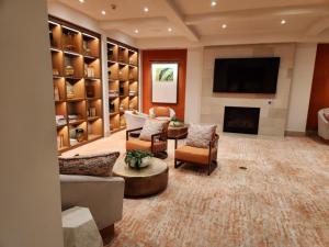 a living room with a fireplace and a flat screen tv at Irvine Spectrum 1 bed 1 bath in Irvine