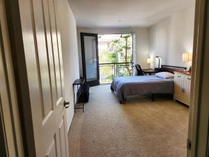 a bedroom with a bed and a television and a window at Irvine Spectrum 1 bed 1 bath in Irvine +57 photos