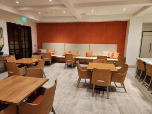 a dining room with wooden tables and chairs at Irvine Spectrum 1 bed 1 bath in Irvine
