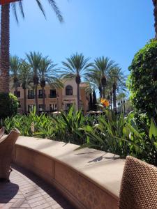 a bench in front of a building with palm trees at Irvine Spectrum 1 bed 1 bath in Irvine