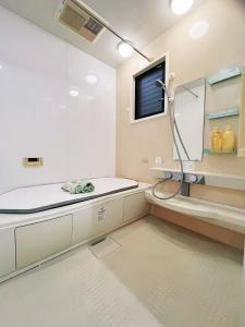 a bathroom with a shower and a sink at Koyasui Guesthouse for Groups Easy Access to Yokohama & Shin-Yokohama in Yokohama +48 photos