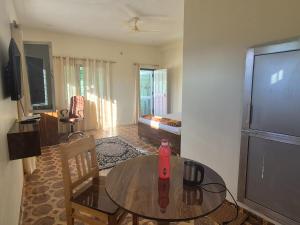 a living room with a table and a bedroom at Roaming Rovers - Pet-Friendly & Peaceful Homestay in Almora in Almora