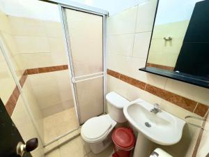 a bathroom with a toilet and a sink and a shower at Hotel Buenavista Valledupar in Valledupar