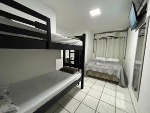a bedroom with two bunk beds in a room at Pousada Dunas Natal in Natal