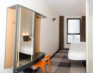 
a bedroom with a bed and a desk at easyHotel Brussels City Centre in Brussels
