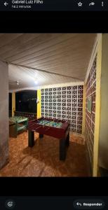 a ping pong table in the middle of a room at Casa Dona Flor in Morretes