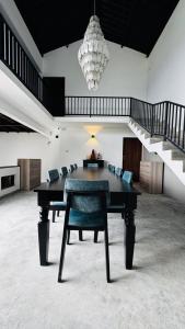 a ping pong table in a room with a staircase at ARHH castle in Ginigathena