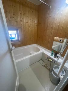 a bathroom with a tub and a toilet at Lakeview Etsu in Lake Toya