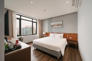 a hotel room with a bed and a window at San Hanoi Hotel & Gaming in Hanoi +49 photos