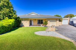 a house with a green lawn in front of it at Ibis Rest Beach House in Geographe