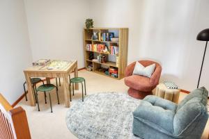 a living room with a table and two chairs and a table sidx sidx at Ibis Rest Beach House in Geographe