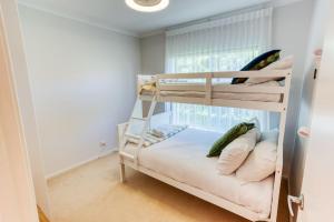 a bedroom with two bunk beds and a window at Ibis Rest Beach House in Geographe