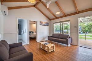 a living room with two couches and a table at BIG4 Ulladulla Beachside Holiday Park in Ulladulla