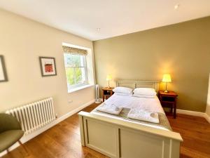 a bedroom with a bed and a window at RIVERBANC in Llangollen
