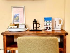 a wooden table with a coffee maker and a tea kettle at RIVERBANC in Llangollen +58 photos