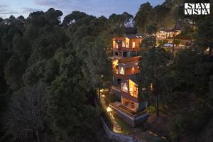 an aerial view of a house in the woods at Sirmour Baag by Vaana - A part of StayVista in Nahna +41 photos