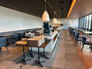 a dining room with tables and chairs in a restaurant at The358 UMI in Fukuoka