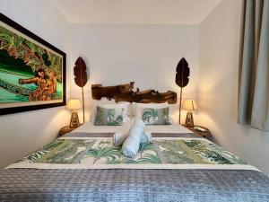 a bedroom with a large bed with two lamps at Te mana Dream apartment in Paea +32 photos