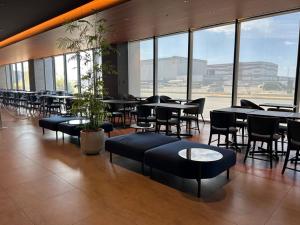 a restaurant with tables and chairs and large windows at The358 UMI in Fukuoka