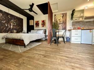 a bedroom with a bed and a table and a kitchen at Guest House in East Devonport in Devonport