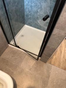 a shower door in a bathroom with a toilet at Guest House in East Devonport in Devonport