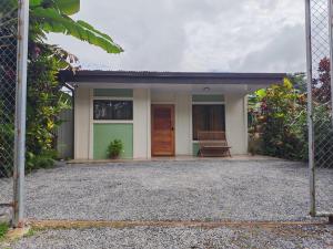 a house with a fence in front of it at Villa Tucano in Fortuna
