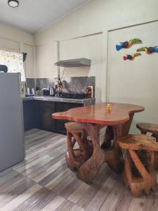 a kitchen with a wooden table in a kitchen at Villa Tucano in Fortuna