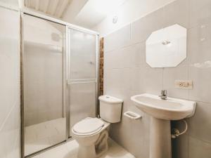a bathroom with a toilet and a sink and a shower at La Jaus by Hope in Guatapé +25 photos