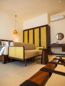 a living room with a couch and a bed at Amayi Resort Nusa Dua in Nusa Dua +50 photos