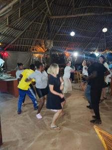a group of people dancing at a party at Tausa Tsavo Eco Lodge in Voi