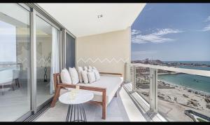 a balcony with a couch and a view of the ocean at Two bedroom Suite in Puerto Peñasco