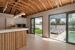 an open kitchen and living room with sliding glass doors at Palm View Suites in Kourouta
