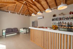 a bar in a room with wooden ceilings at Palm View Suites in Kourouta